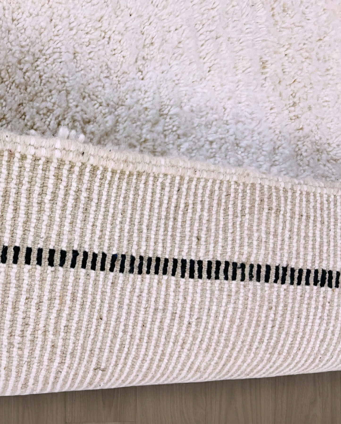 IKRAM Beni Ourain ivory solid border Moroccan rug close-up showing hand-knotted wool texture and pile detail 2, by NURA