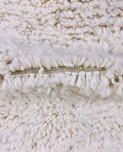 IKRAM Beni Ourain ivory solid border Moroccan rug close-up showing hand-knotted wool texture and pile detail 3, by NURA