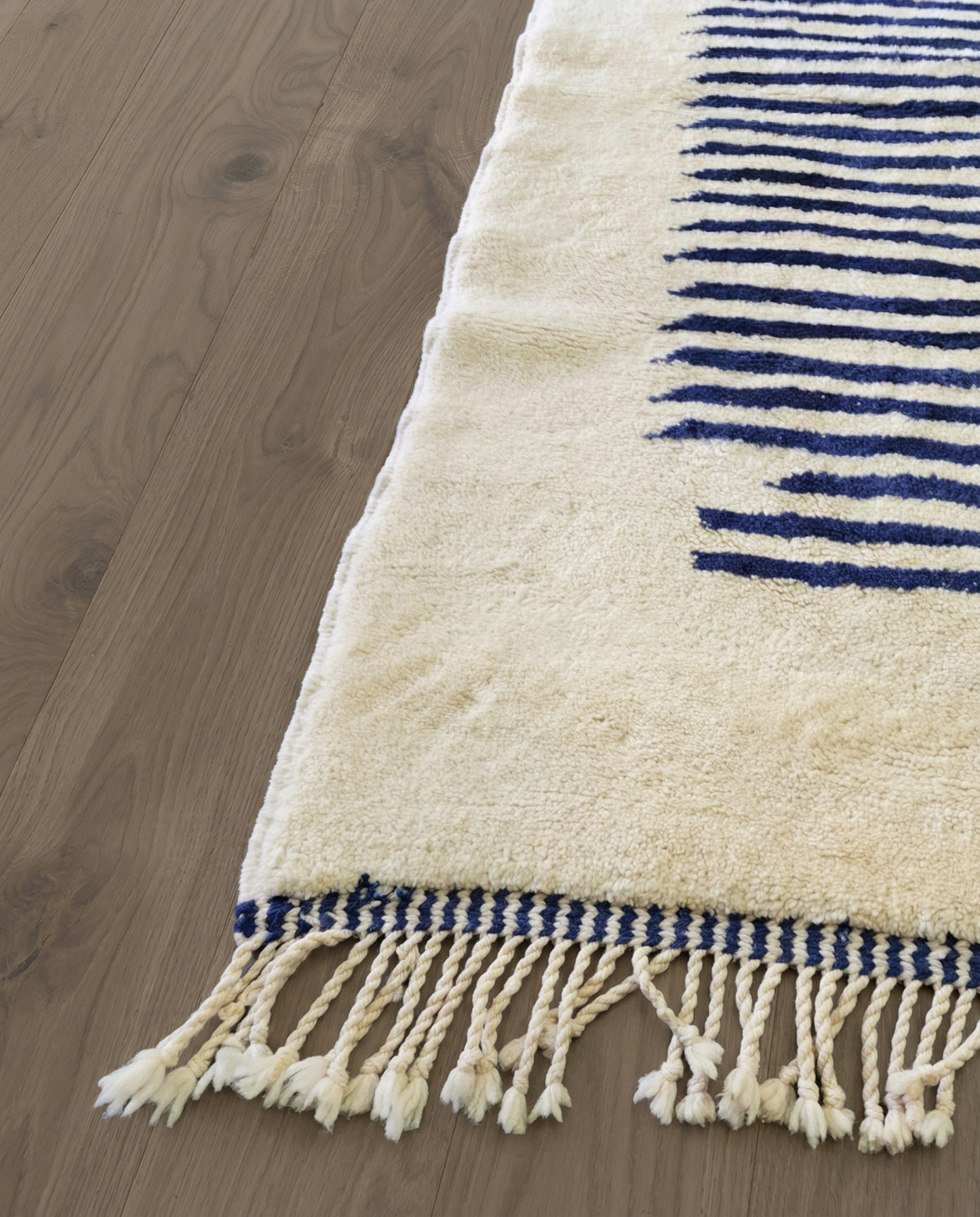 INES Beni Ourain cream striped central medallion Moroccan rug close-up of hand-tied fringe and kilim band detail, by NURA