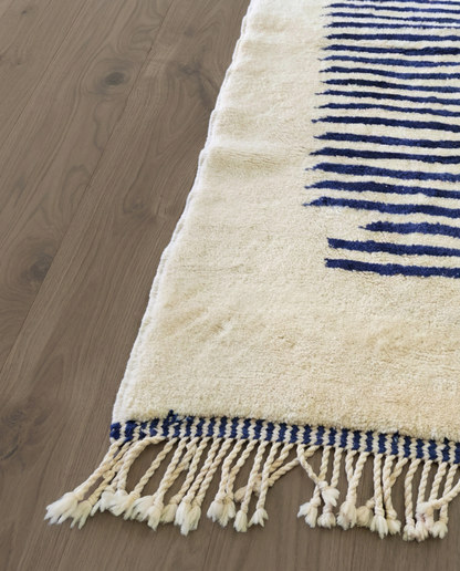INES Beni Ourain cream striped central medallion Moroccan rug close-up of hand-tied fringe and kilim band detail, by NURA