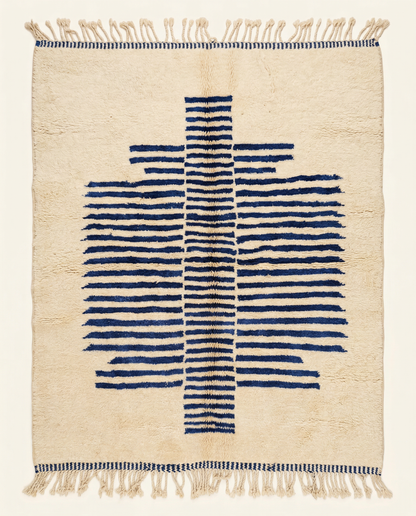 Plush cream Beni Ourain Moroccan rug with a bold cobalt blue striped central medallion and high pile, by NURA.
