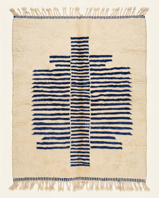 Plush cream Beni Ourain Moroccan rug with a bold cobalt blue striped central medallion and high pile, by NURA.