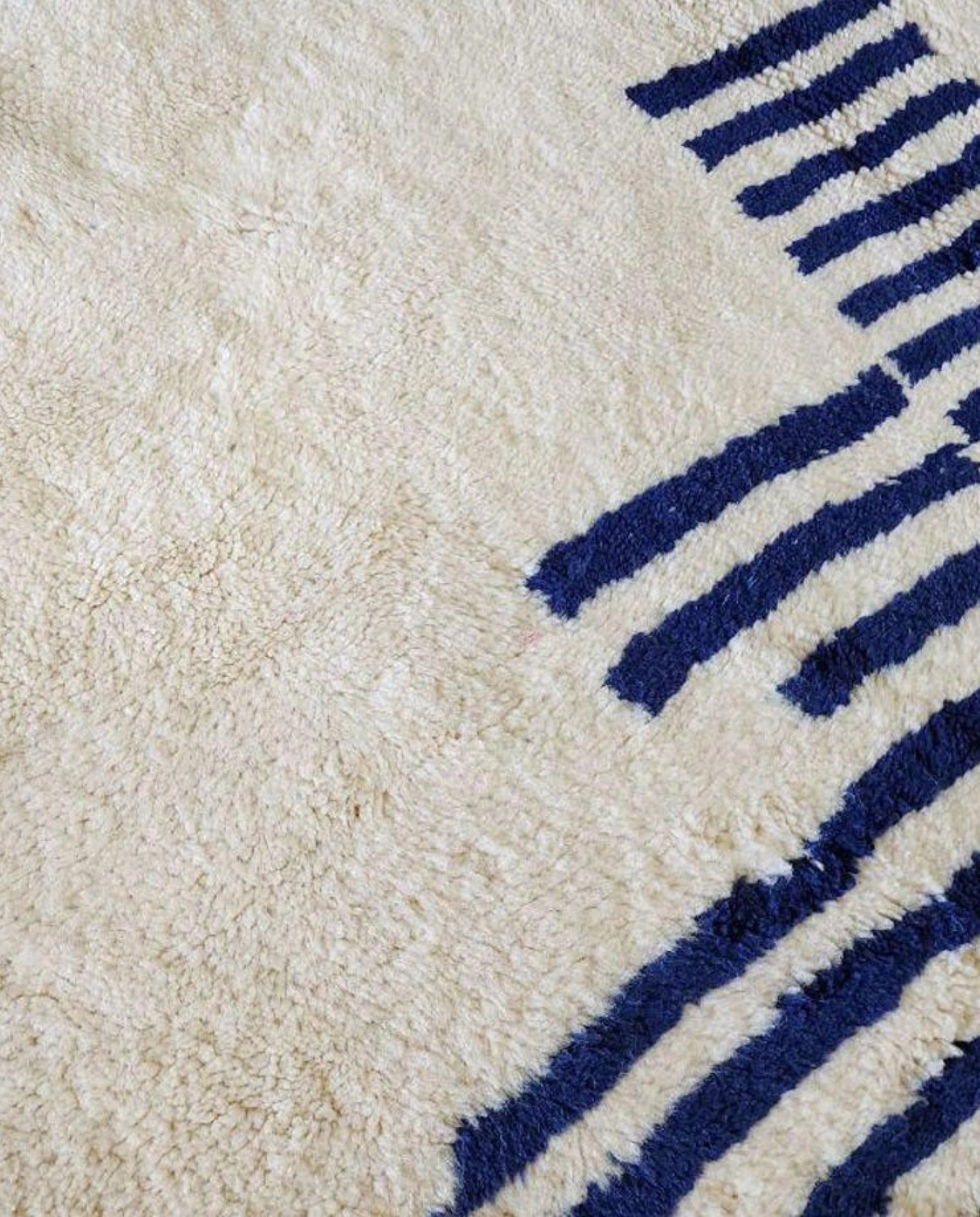INES Beni Ourain cream striped central medallion Moroccan rug close-up showing hand-knotted wool texture and pile detail 1, by NURA