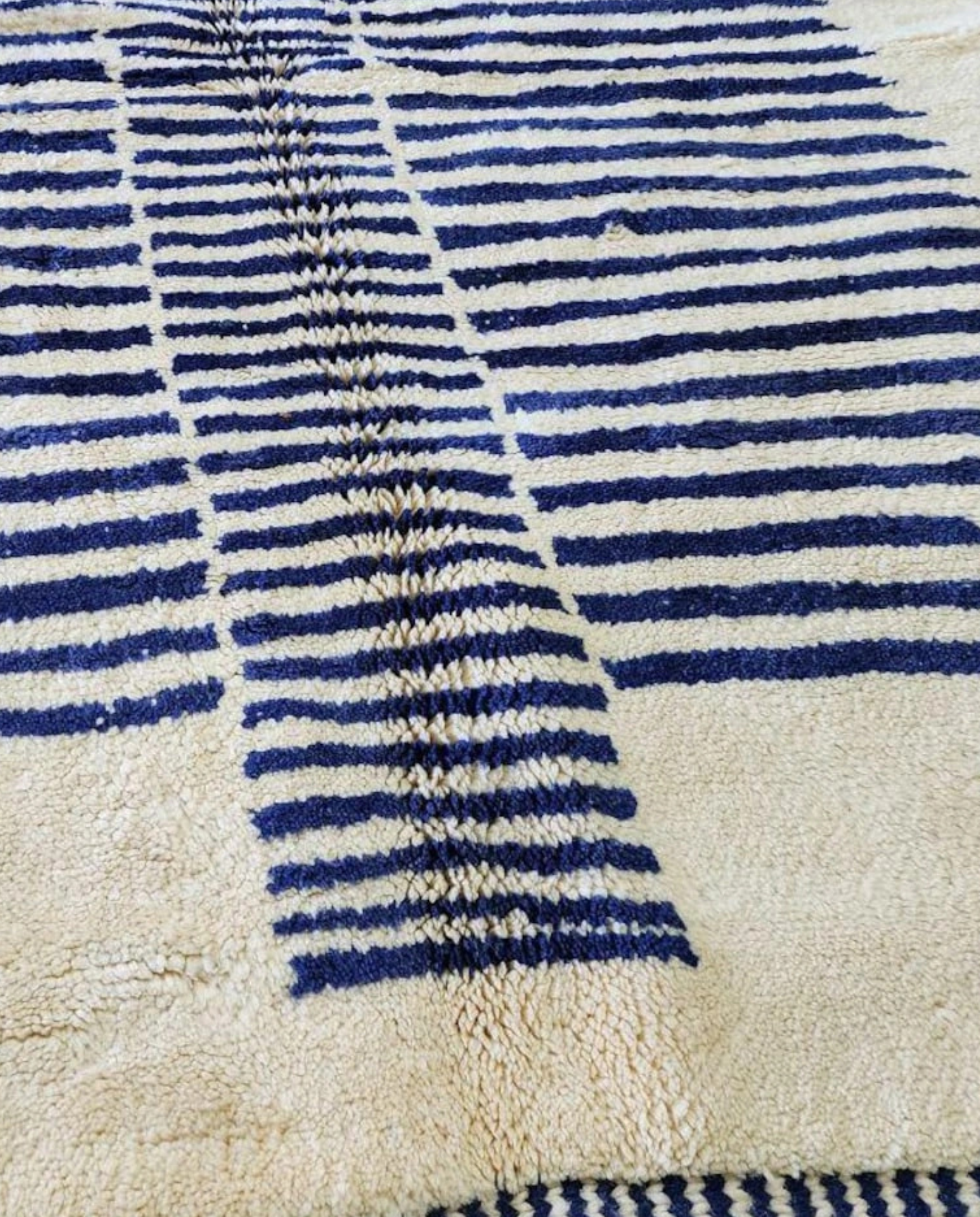 INES Beni Ourain cream striped central medallion Moroccan rug close-up showing hand-knotted wool texture and pile detail 2, by NURA