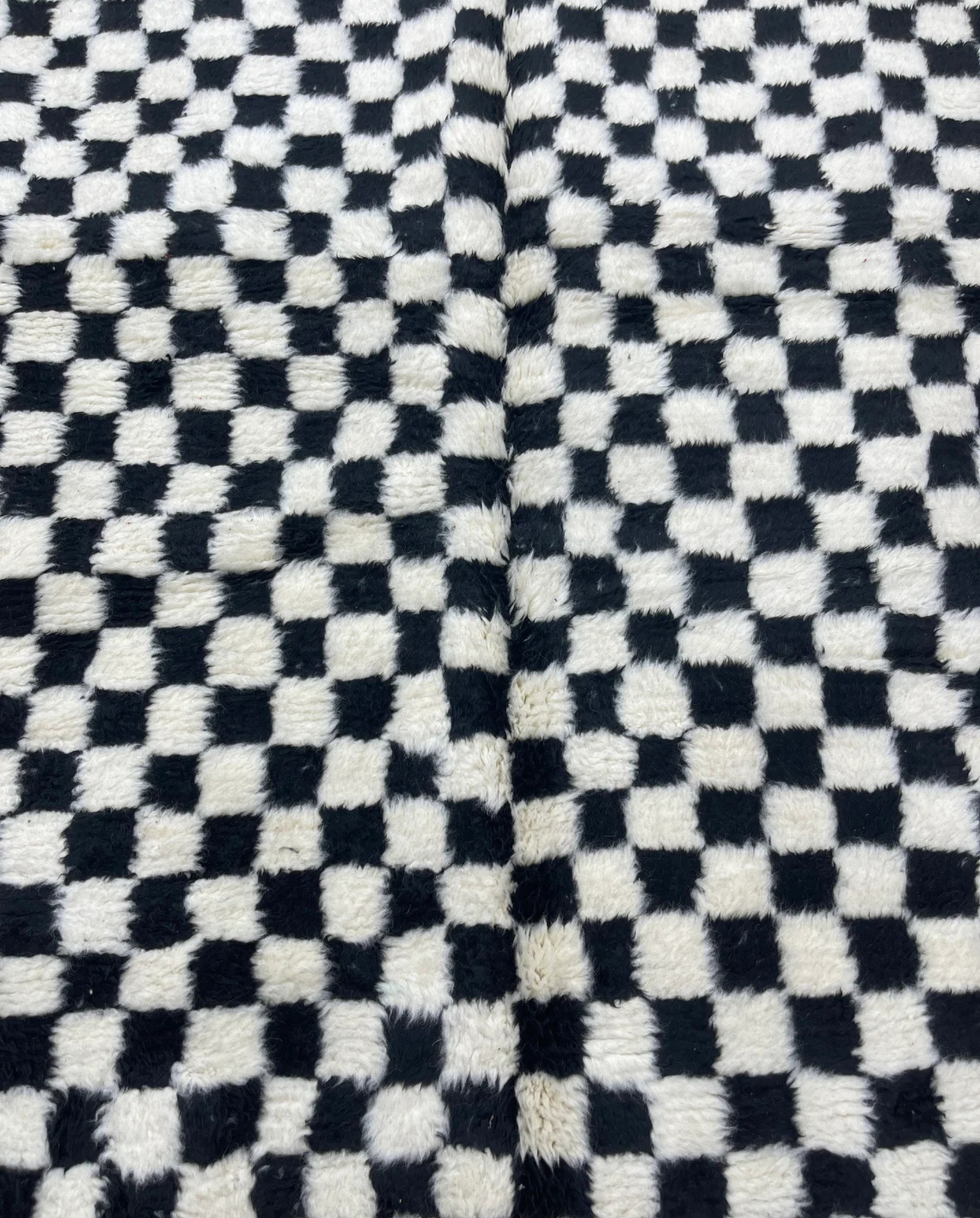 JAMILA Beni Ourain black checker grid Moroccan rug close-up showing hand-knotted wool texture and pile detail, by NURA