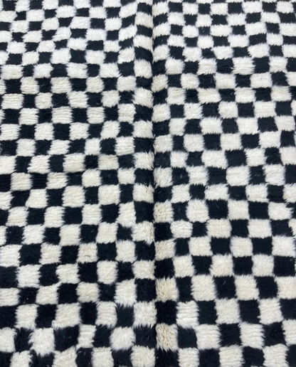 JAMILA Beni Ourain black checker grid Moroccan rug close-up showing hand-knotted wool texture and pile detail, by NURA