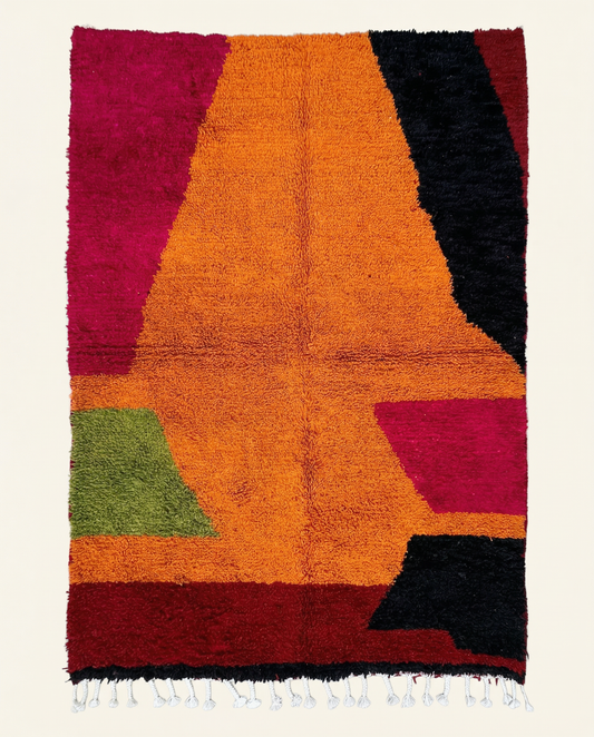Plush Azilal Moroccan rug with bold abstract color blocks in vibrant orange, red, and black, by NURA.