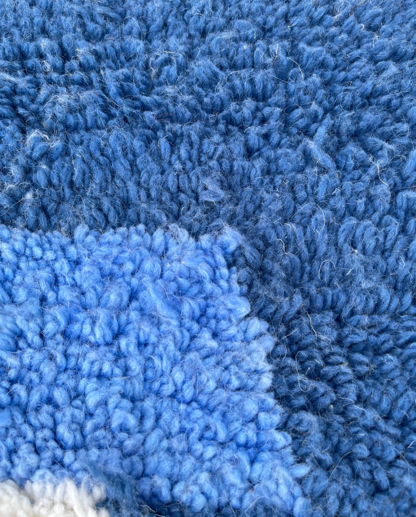 JIHANE Azilal cream abstract color block Moroccan rug close-up showing hand-knotted wool texture and pile detail, by NURA