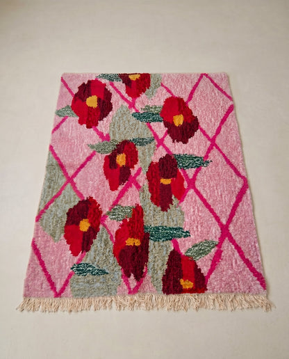 JORIA Boujad pink diamond lattice Moroccan rug displayed on a parquet wood floor, showing full fringe and edge detail, by NURA
