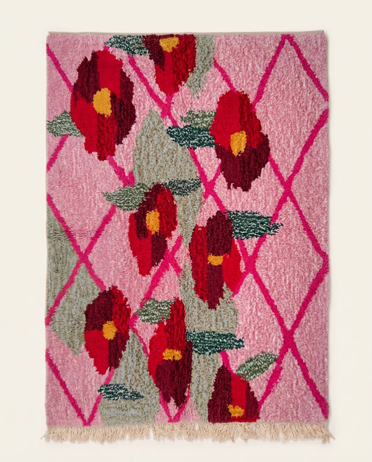 Vibrant pink Moroccan Boujad rug featuring a bright magenta diamond lattice and large red floral motifs by NURA.