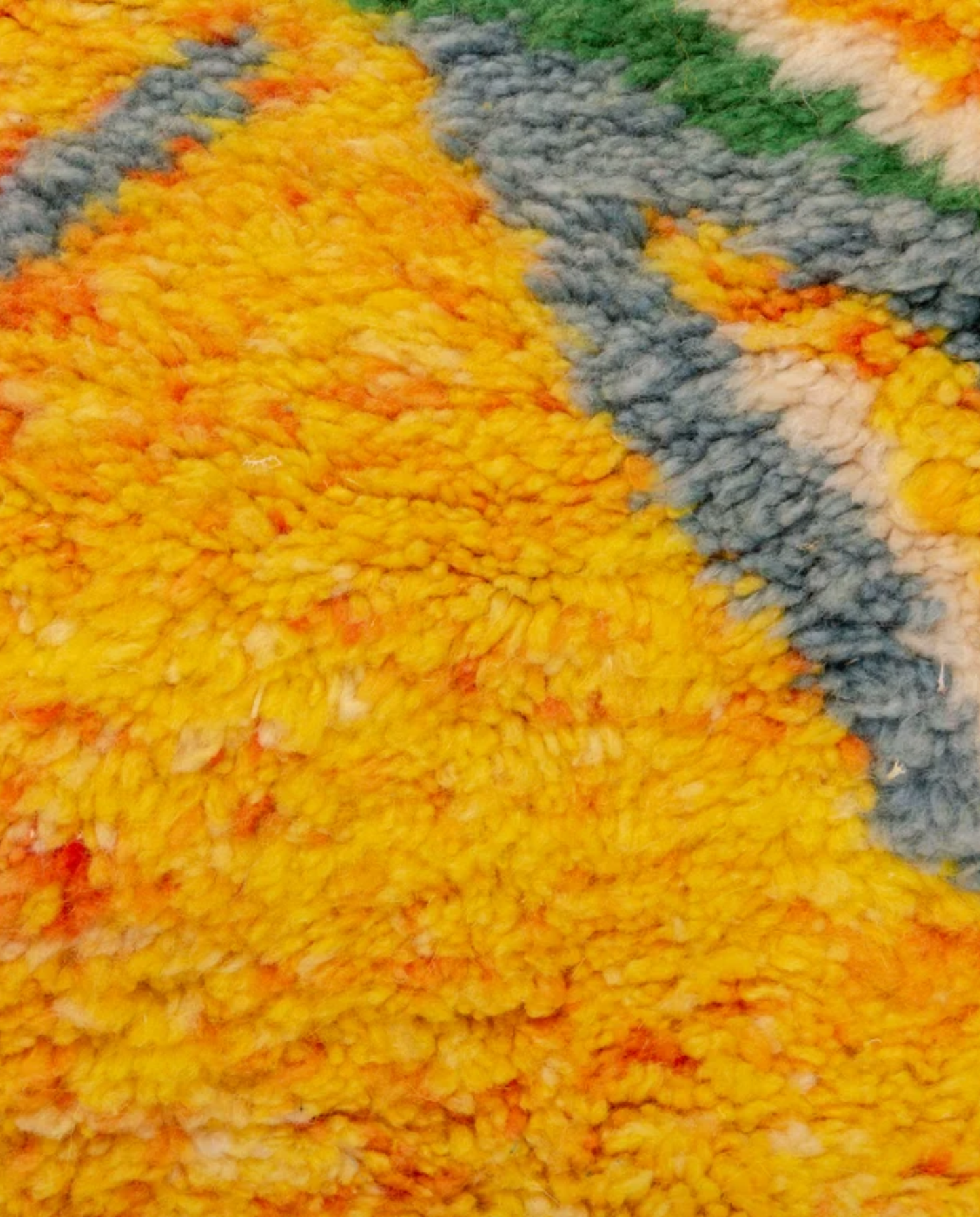 KAMILA Azilal saffron abstract branch motif Moroccan rug close-up showing hand-knotted wool texture and pile detail, by NURA