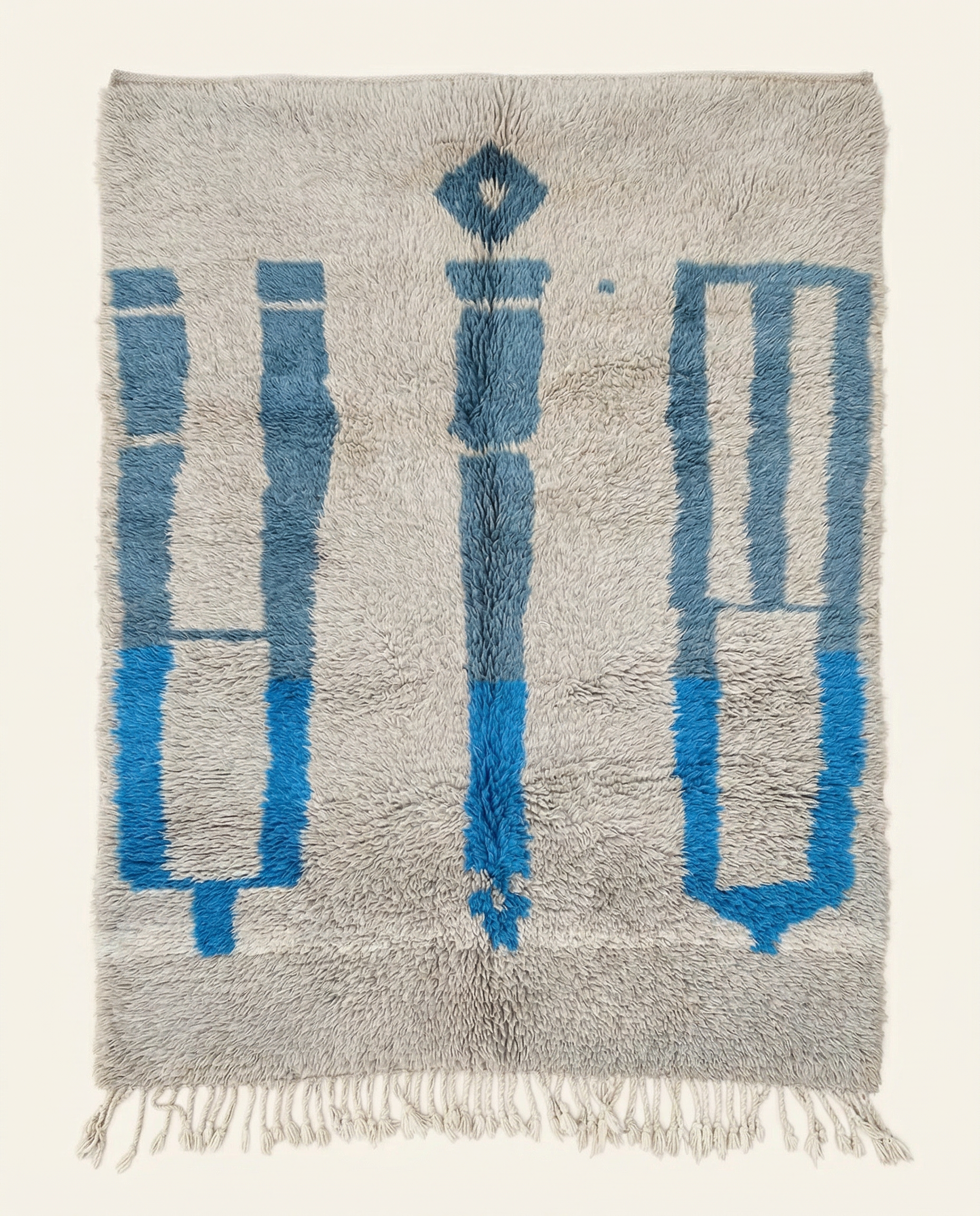 Plush silver-grey Beni Ourain Moroccan rug with bold cobalt blue abstract motifs and a thick high pile, by NURA.