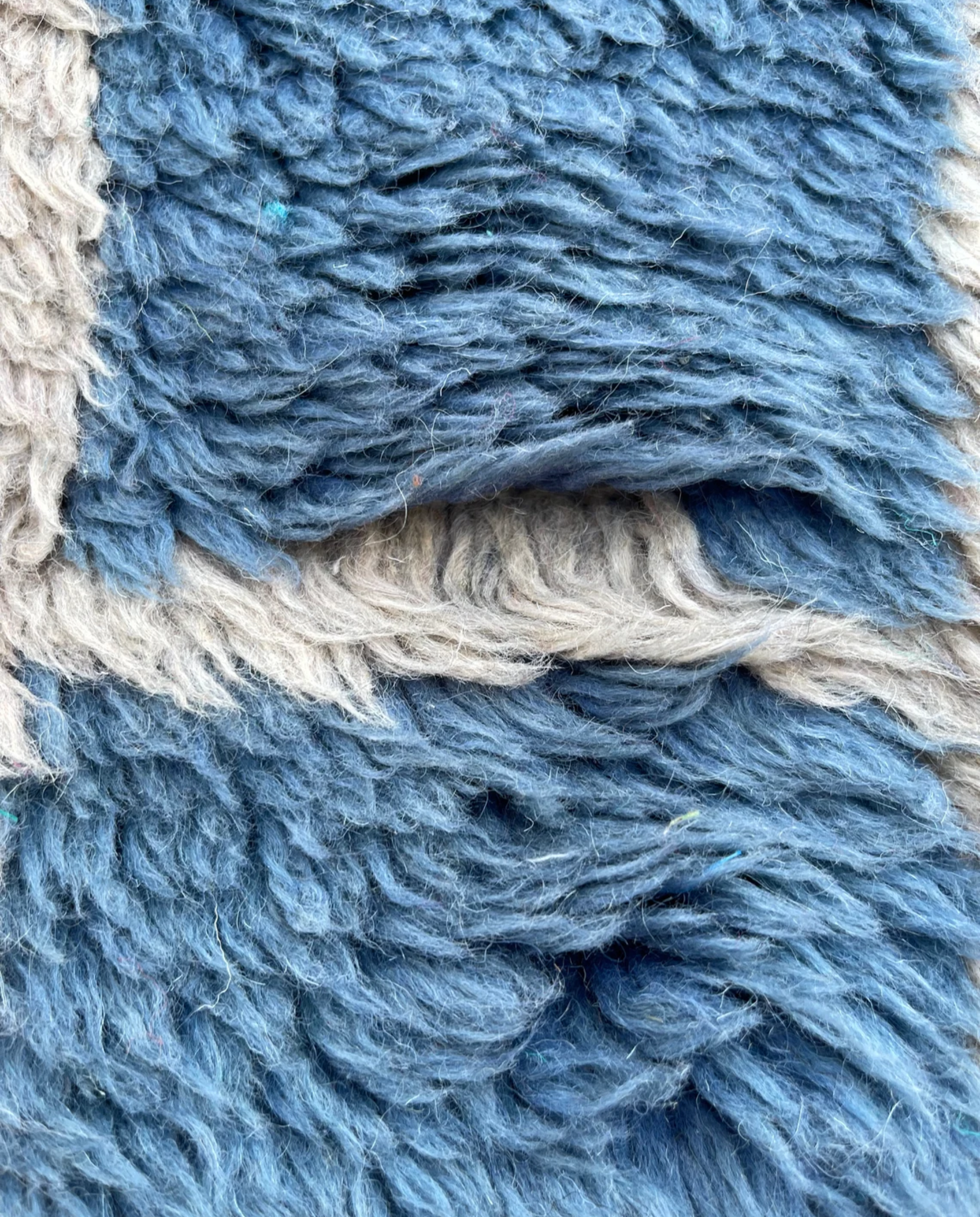 KAOUTAR Beni Ourain grey bold abstract motifs Moroccan rug close-up showing hand-knotted wool texture and pile detail, by NURA