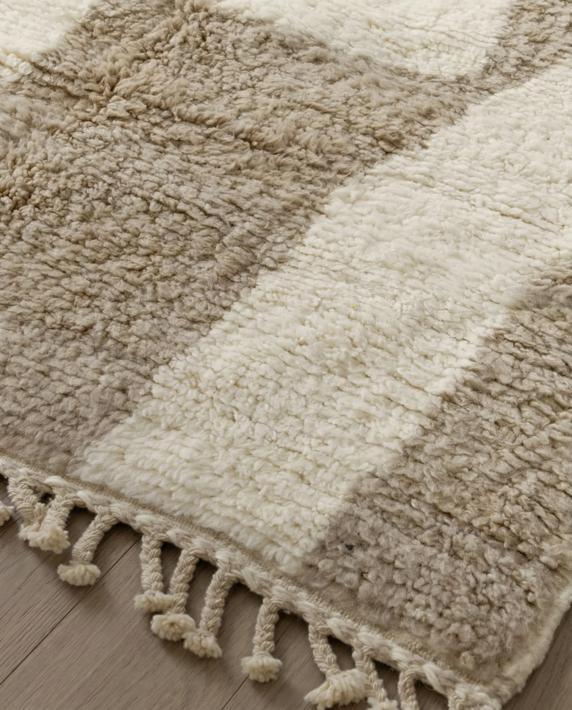 KARIMA Beni Ourain cream abstract geometric blocks Moroccan rug close-up of hand-tied fringe and kilim band detail, by NURA