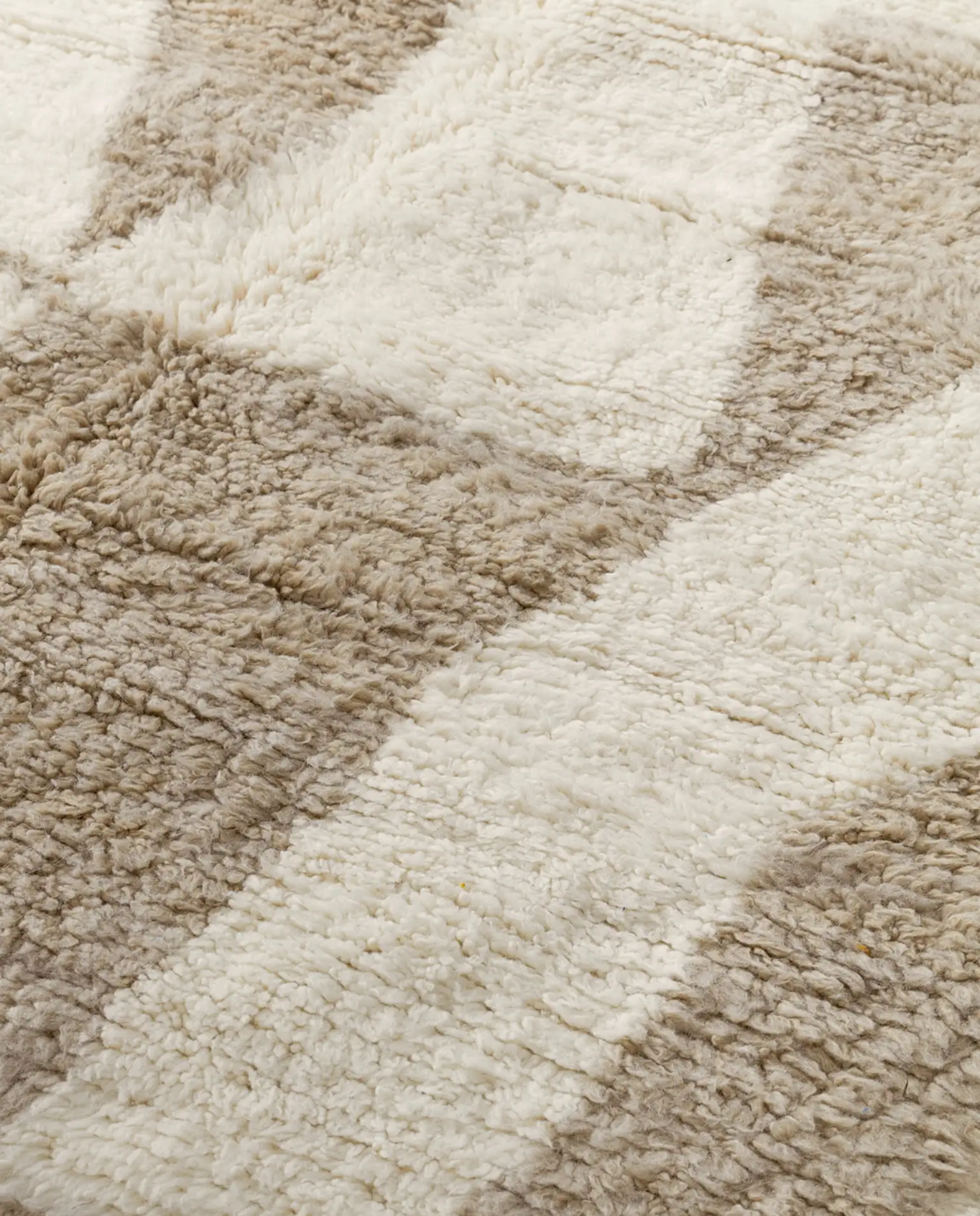 KARIMA Beni Ourain cream abstract geometric blocks Moroccan rug close-up showing hand-knotted wool texture and pile detail, by NURA