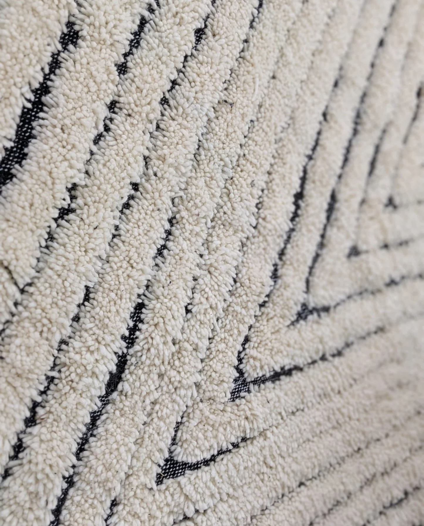 KARMA Azilal cream chevron lines Moroccan rug close-up showing hand-knotted wool texture and pile detail, by NURA