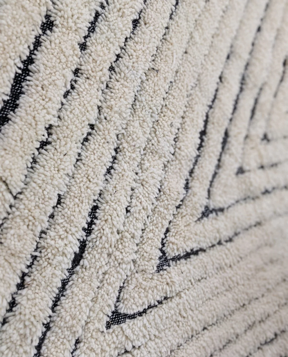 KARMA Azilal cream chevron lines Moroccan rug close-up showing hand-knotted wool texture and pile detail, by NURA