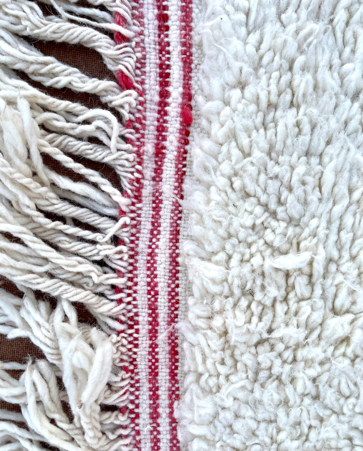 KHAWLA Azilal ivory abstract central motif Moroccan rug close-up of hand-tied fringe and kilim band detail, by NURA