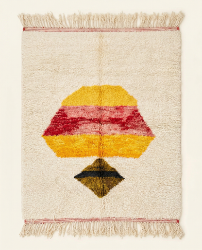 Plush ivory Azilal Moroccan rug with a bold central abstract motif in yellow, pink, and red, by NURA.