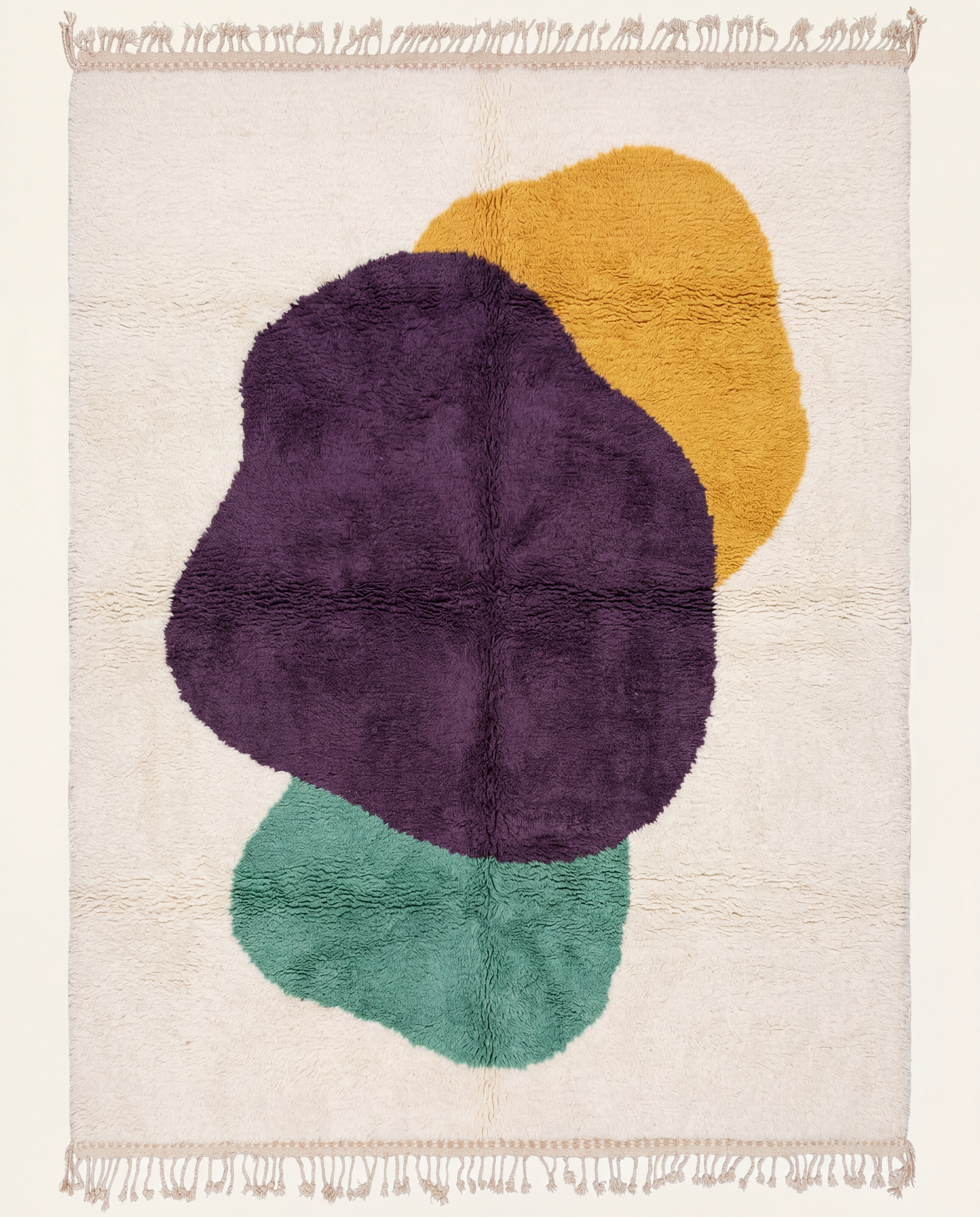 A plush cream Azilal Moroccan rug by NURA featuring bold organic abstract shapes in deep plum, mustard yellow, and muted teal.