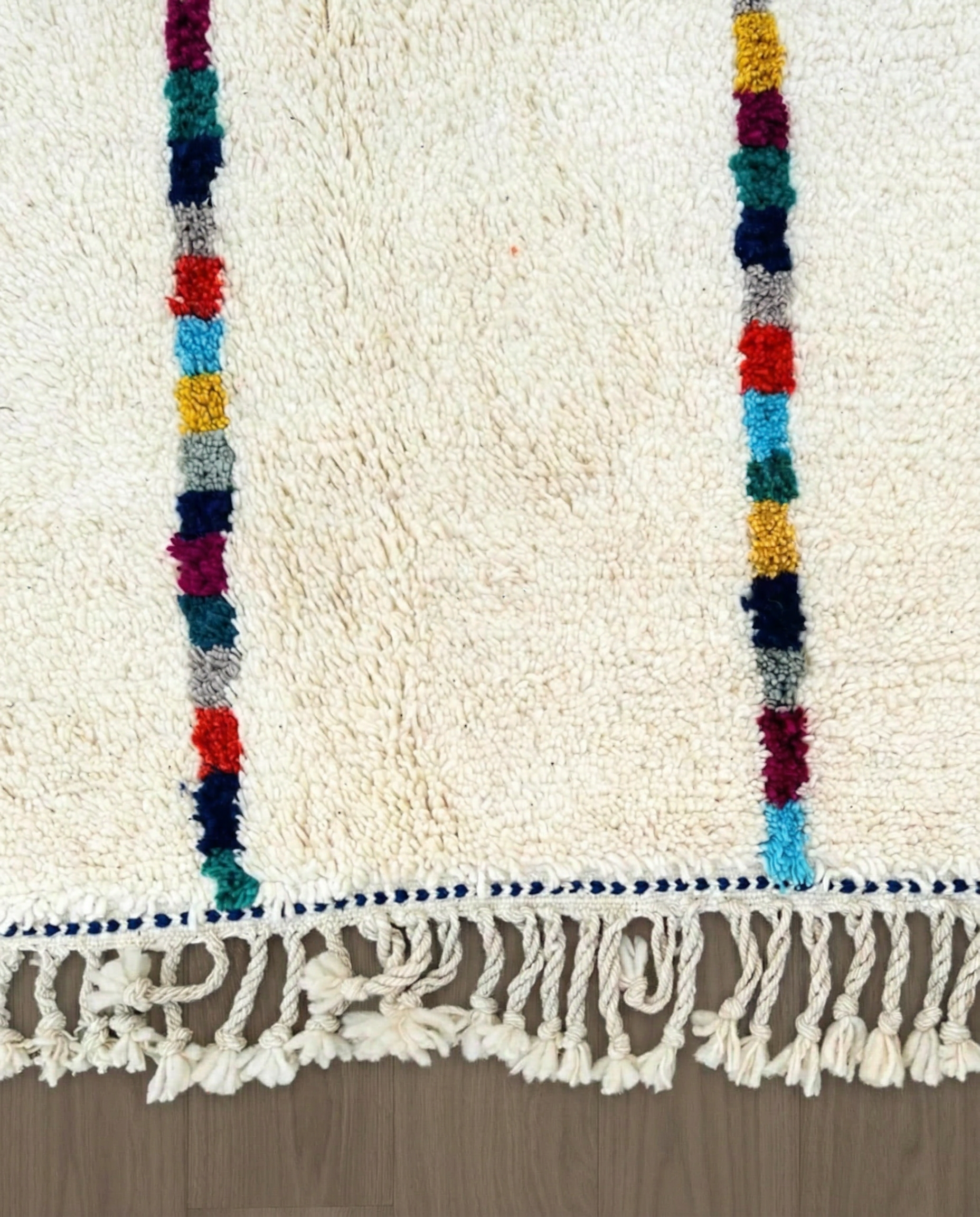 LIANE Azilal cream vertical color block stripes Moroccan rug close-up of hand-tied fringe and kilim band detail, by NURA