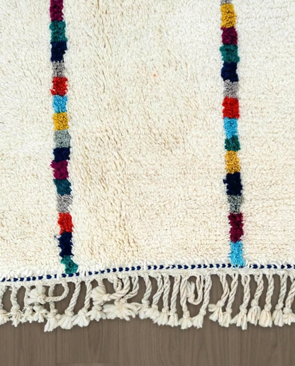 LIANE Azilal cream vertical color block stripes Moroccan rug close-up of hand-tied fringe and kilim band detail, by NURA