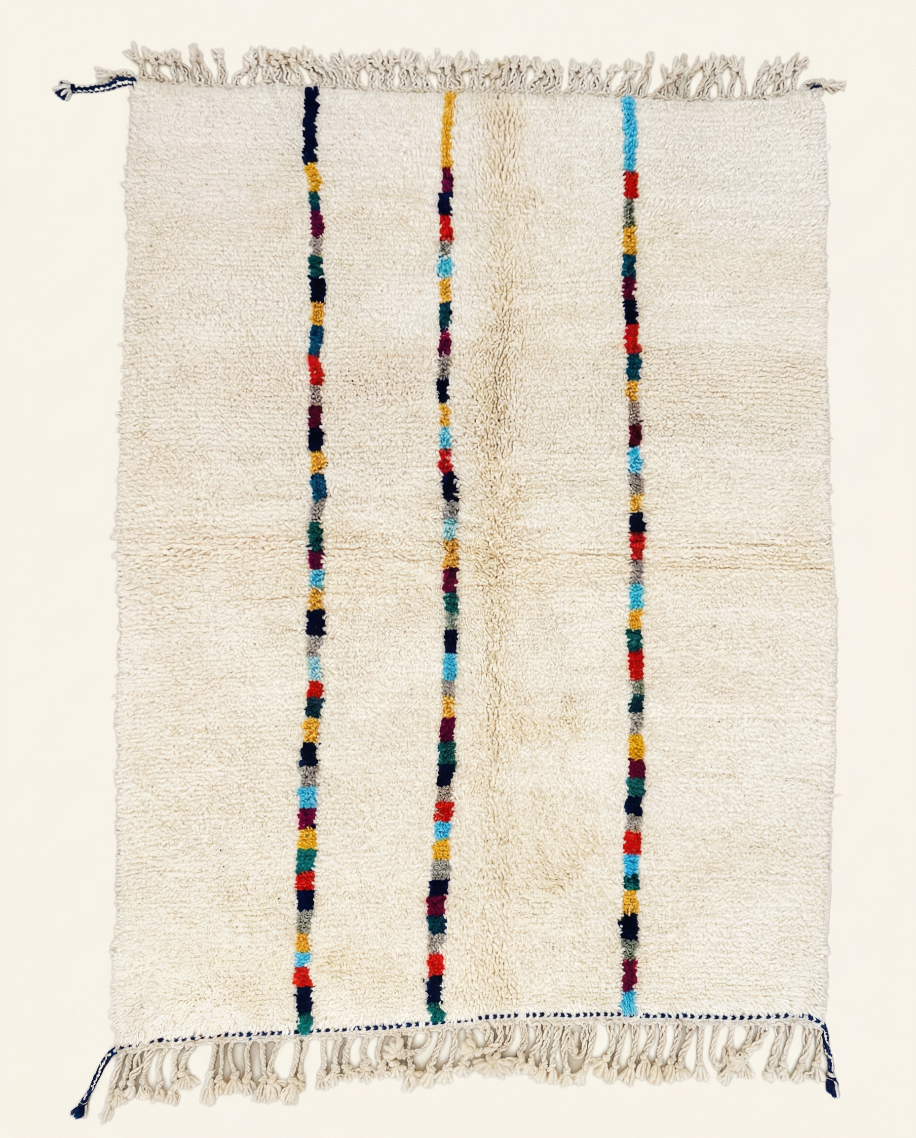 Plush cream Azilal Moroccan rug with three vertical stripes of vibrant multicolor blocks and a high pile, by NURA.