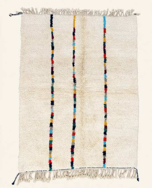 Plush cream Azilal Moroccan rug with three vertical stripes of vibrant multicolor blocks and a high pile, by NURA.