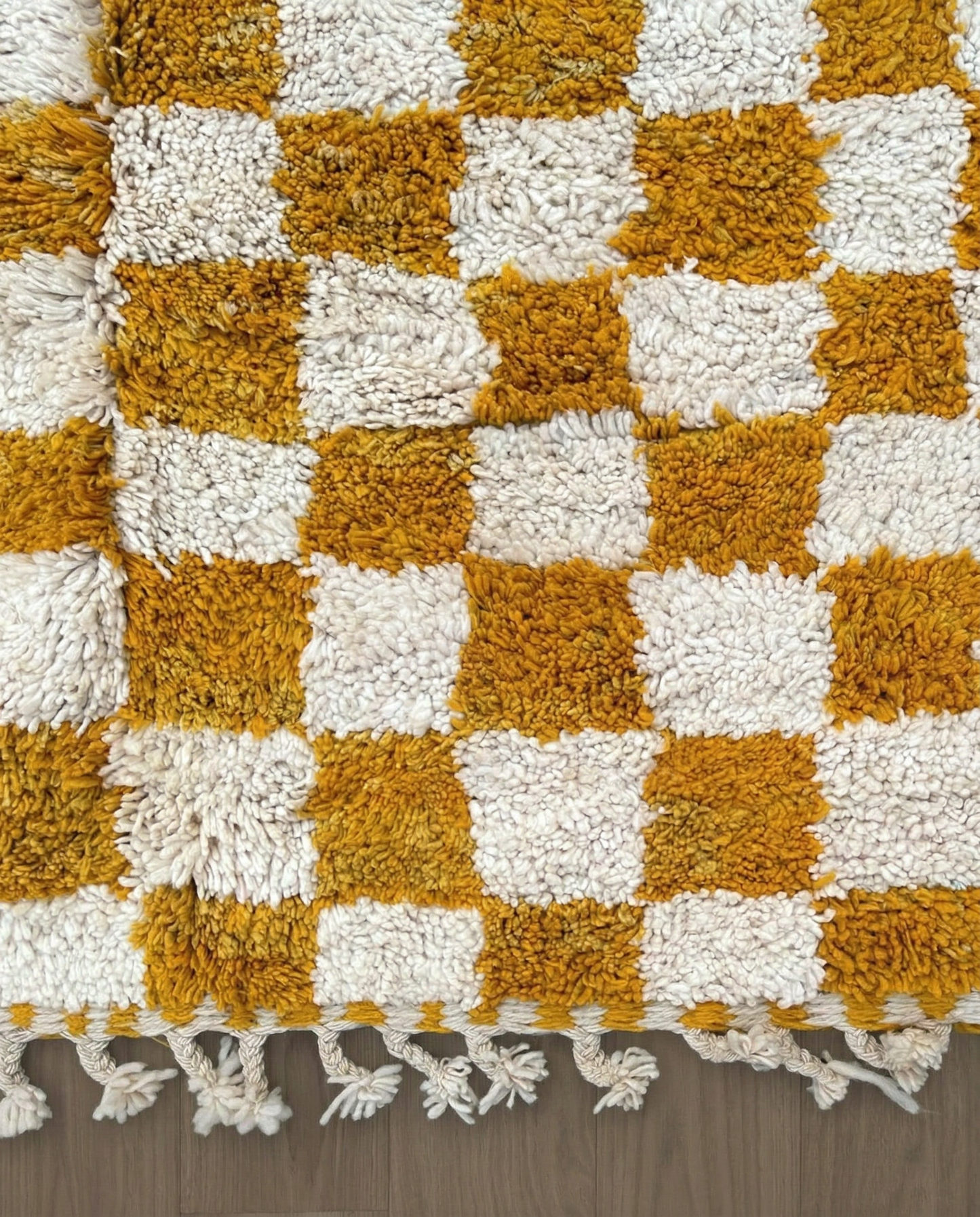 MAHA Beni Ourain mustard checker grid Moroccan rug close-up of hand-tied fringe and kilim band detail, by NURA