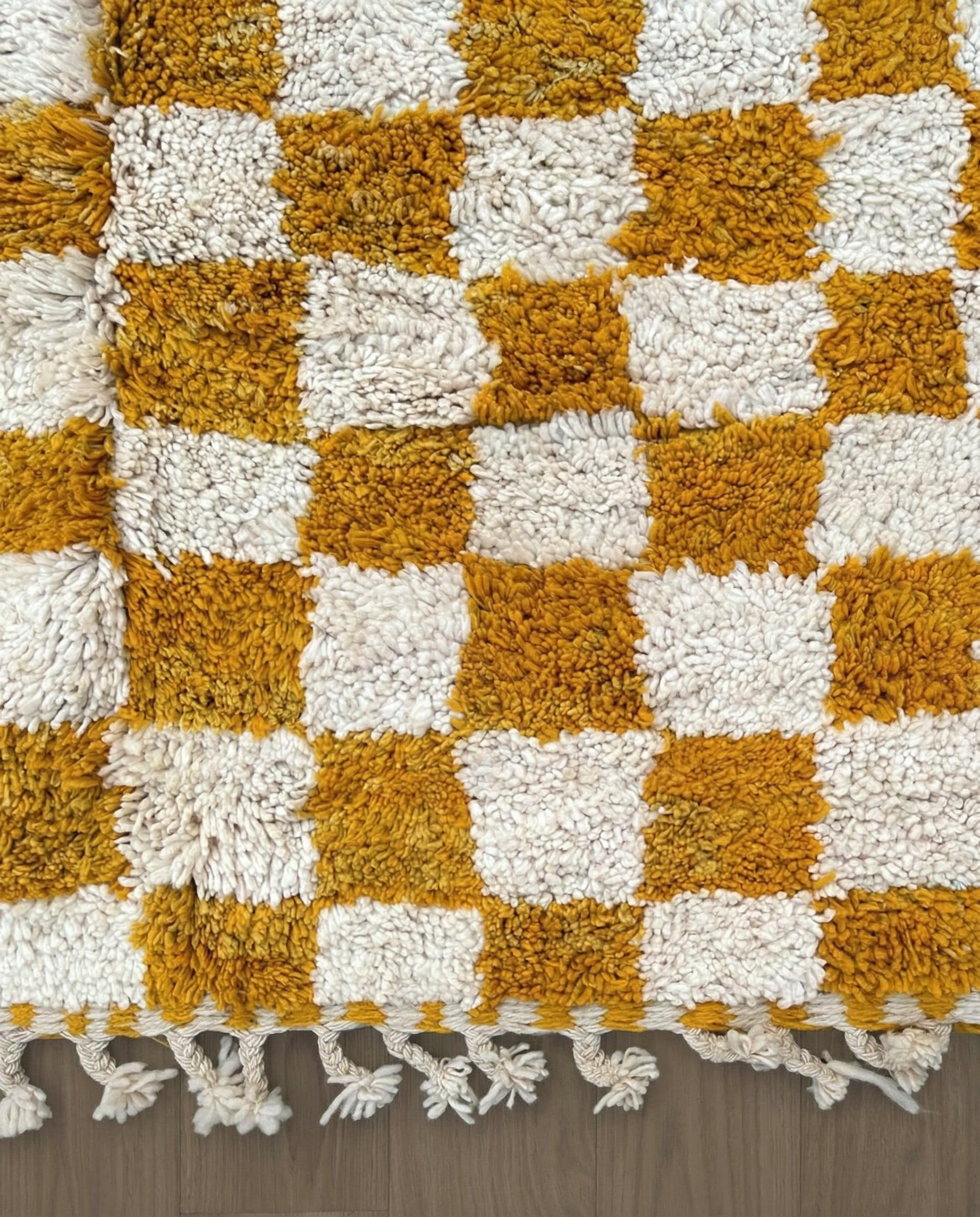 MAHA Beni Ourain mustard checker grid Moroccan rug close-up of hand-tied fringe and kilim band detail, by NURA