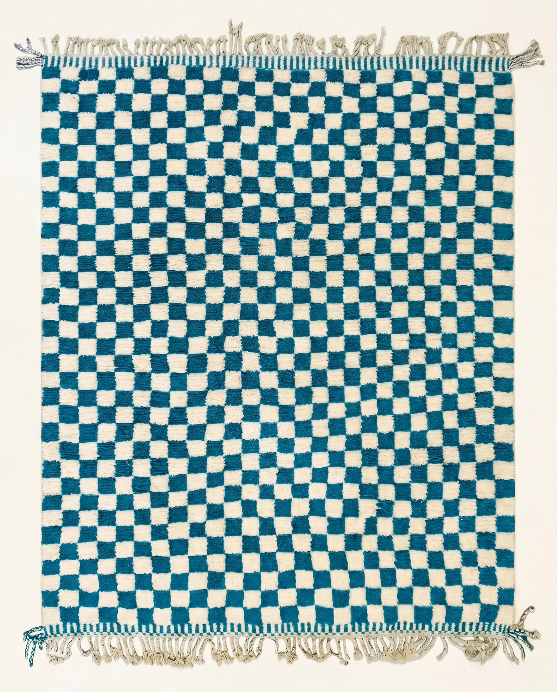A plush blue and cream checkerboard Moroccan rug hand-knotted from virgin wool, shown flat from above by NURA.
