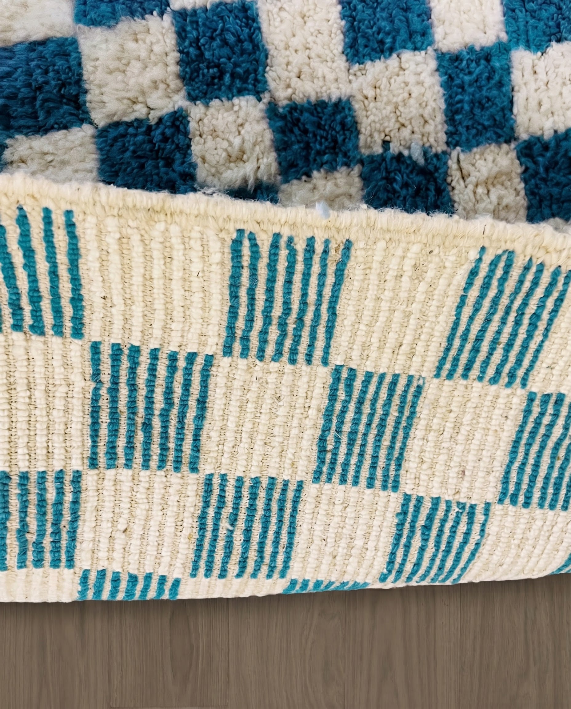 MAJDA Beni Ourain blue checker grid Moroccan rug close-up showing hand-knotted wool texture and pile detail 2, by NURA