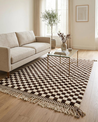 Chocolate and cream checkerboard Moroccan rug by NURA styled in a modern living room, adding plush texture and bold contrast.