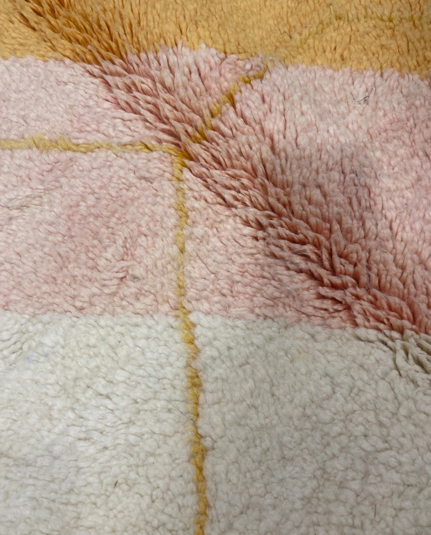 MALAK Beni Ourain cream abstract color block Moroccan rug close-up showing hand-knotted wool texture and pile detail, by NURA