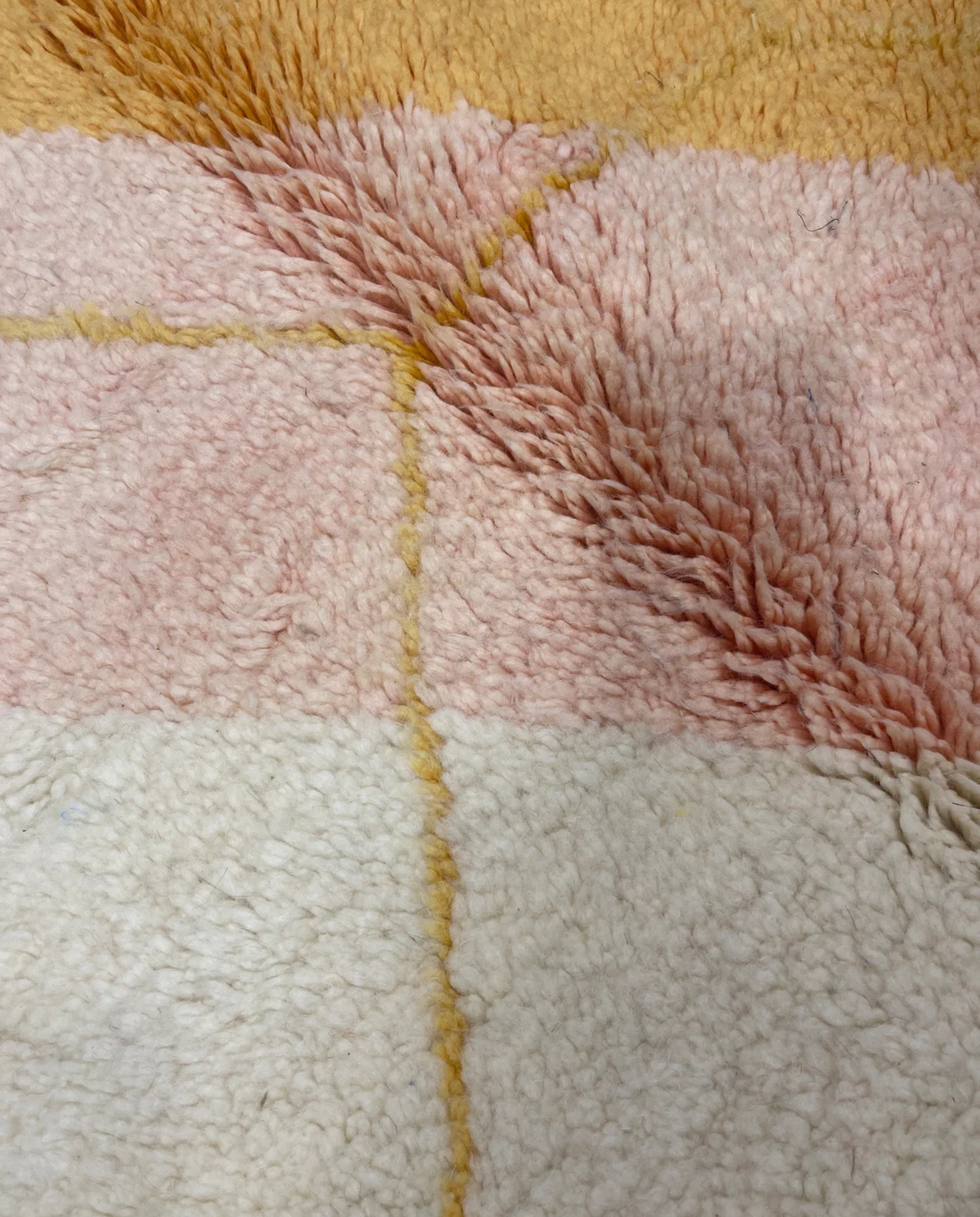 MALAK Beni Ourain cream abstract color block Moroccan rug close-up showing hand-knotted wool texture and pile detail, by NURA