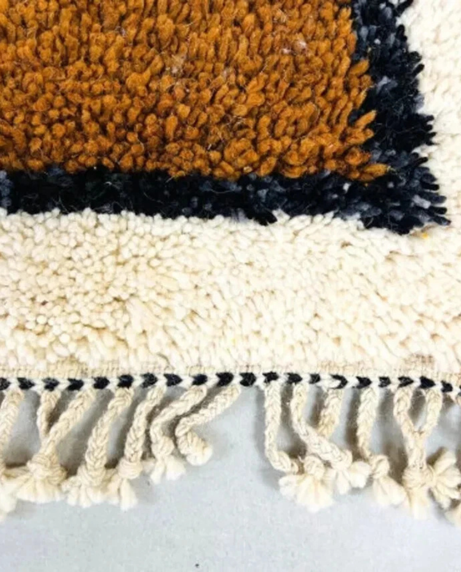 MALIKA Azilal ivory abstract color block Moroccan rug close-up of hand-tied fringe and kilim band detail, by NURA
