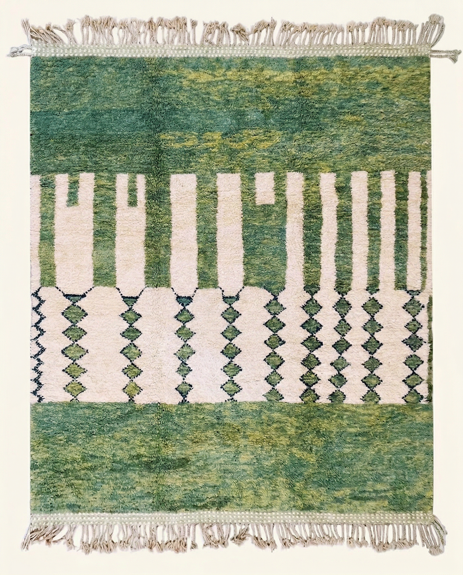 Plush sage green and cream Mrirt Moroccan rug with a bold asymmetrical color block and striped design, by NURA.