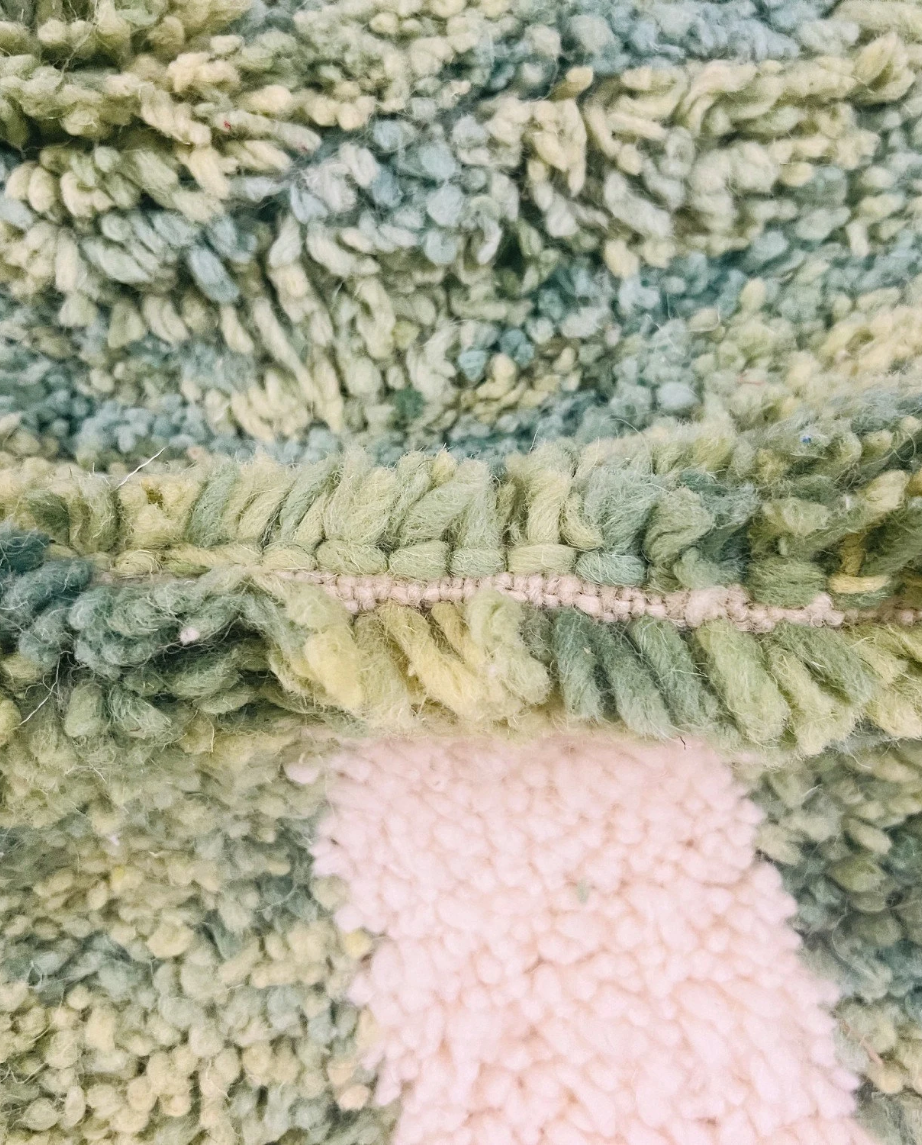 MANAL Mrirt sage asymmetrical color block Moroccan rug close-up showing hand-knotted wool texture and pile detail 3, by NURA