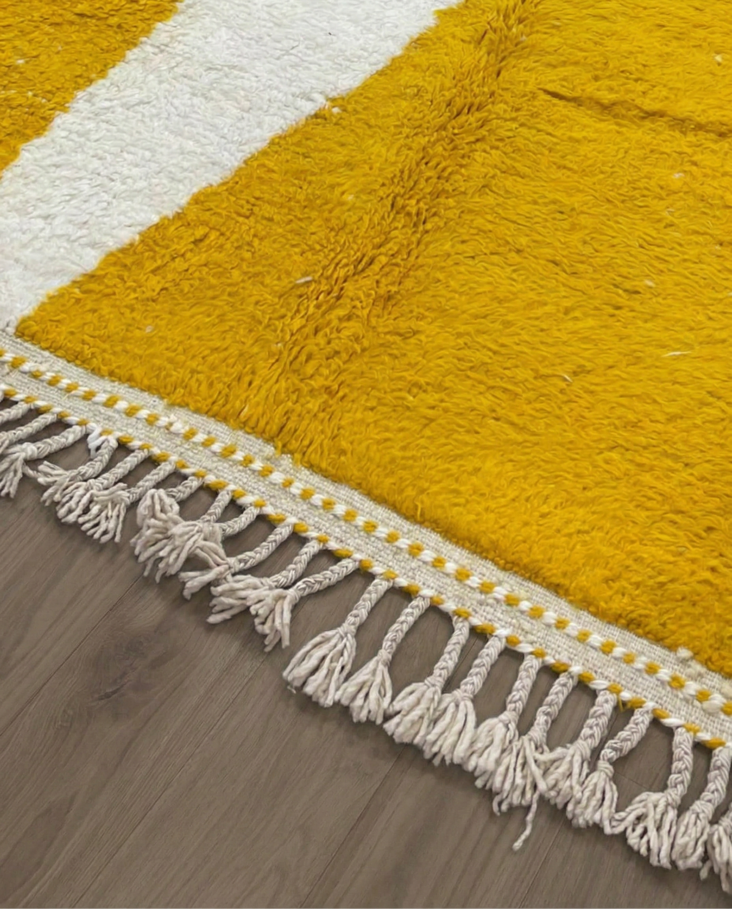 MARWA Beni Ourain mustard abstract color block Moroccan rug close-up of hand-tied fringe and kilim band detail, by NURA