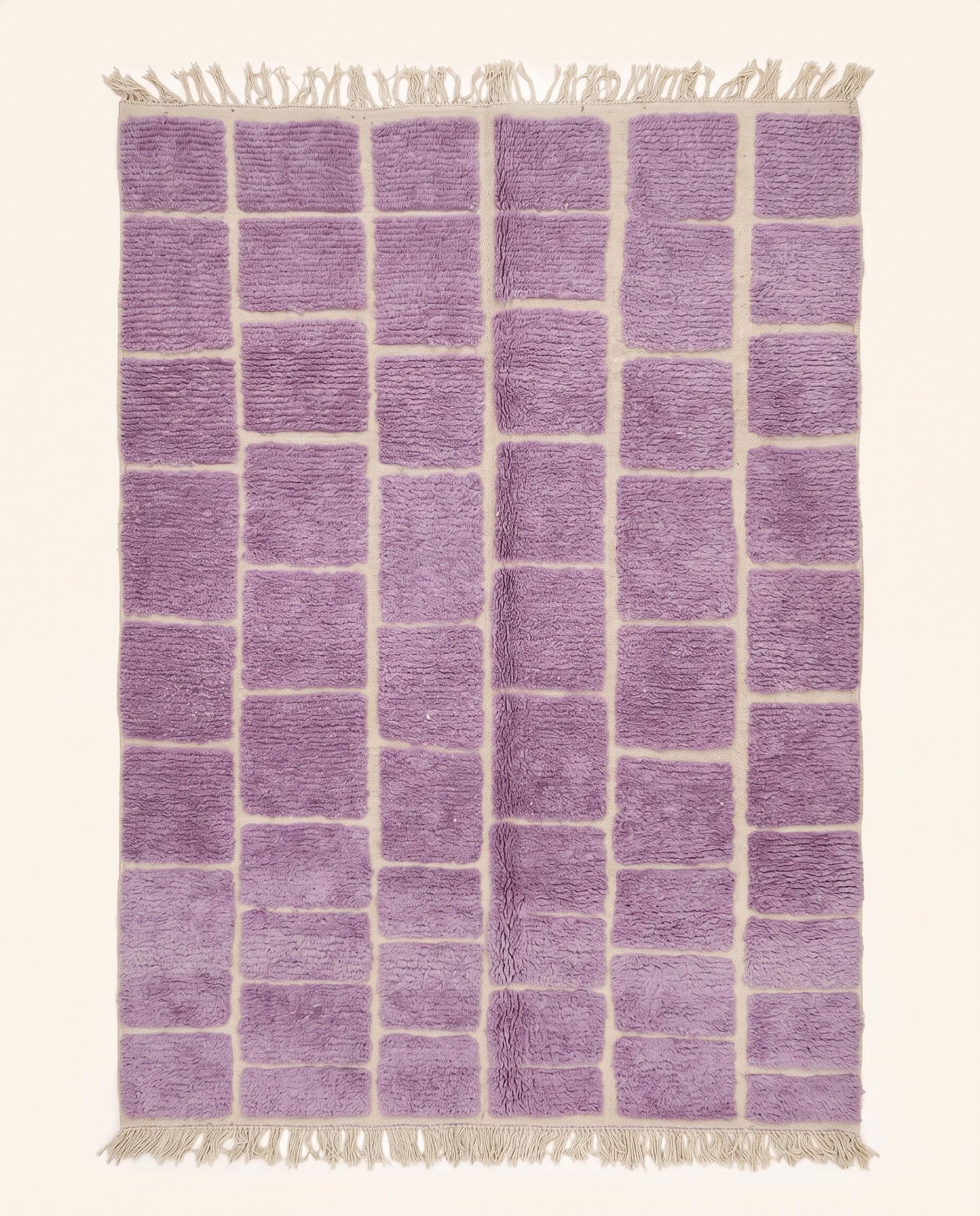 A plush purple Moroccan rug featuring a modern cream checker grid pattern, hand-knotted from soft wool by NURA.