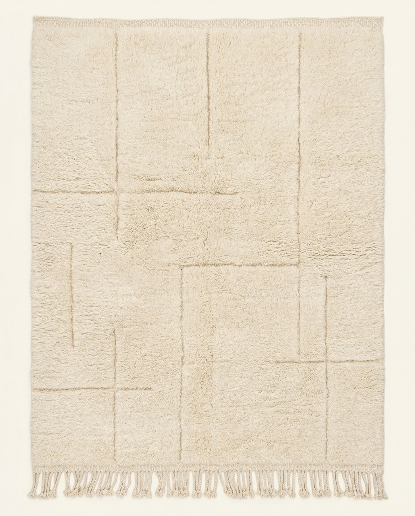 Plush cream Beni Ourain Moroccan rug with a modern carved geometric grid and thick high pile, by NURA.