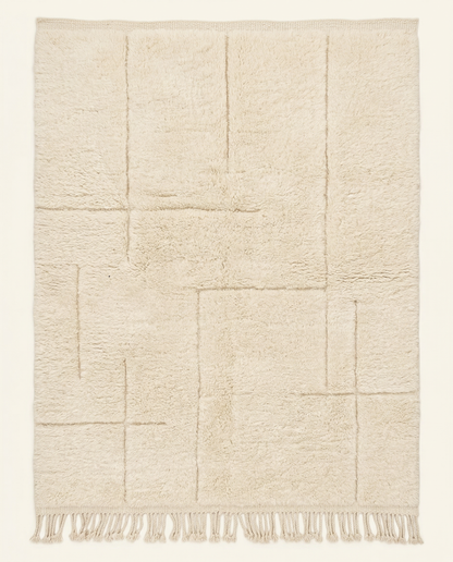 Plush cream Beni Ourain Moroccan rug with a modern carved geometric grid and thick high pile, by NURA.