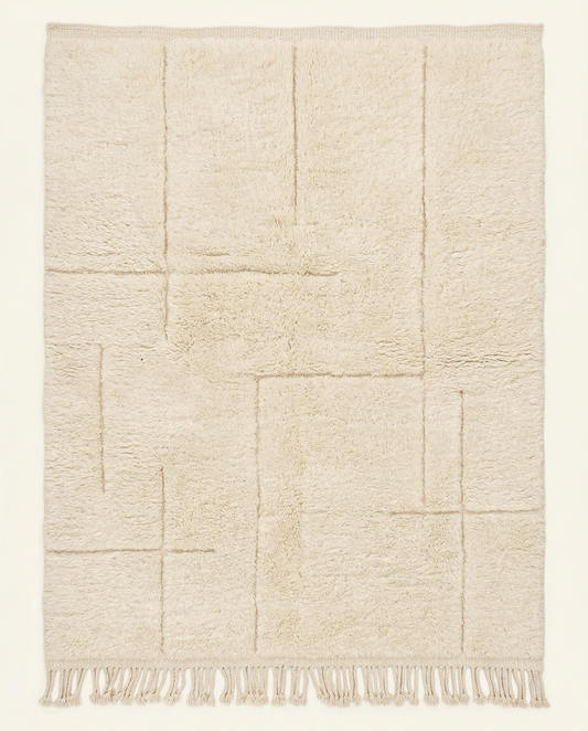 Plush cream Beni Ourain Moroccan rug with a modern carved geometric grid and thick high pile, by NURA.