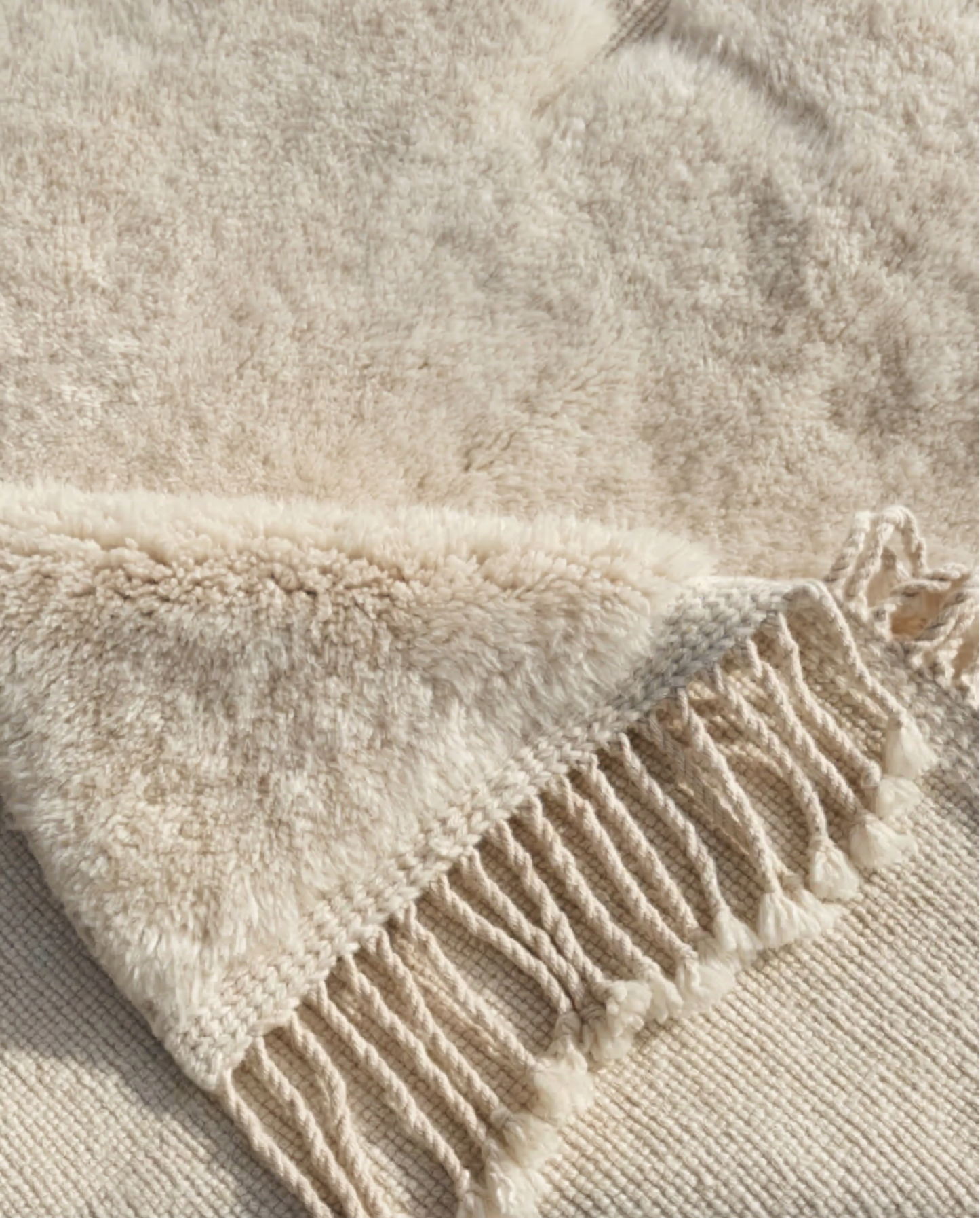 MAYA Beni Ourain cream carved geometric grid Moroccan rug close-up showing hand-knotted wool texture and pile detail, by NURA