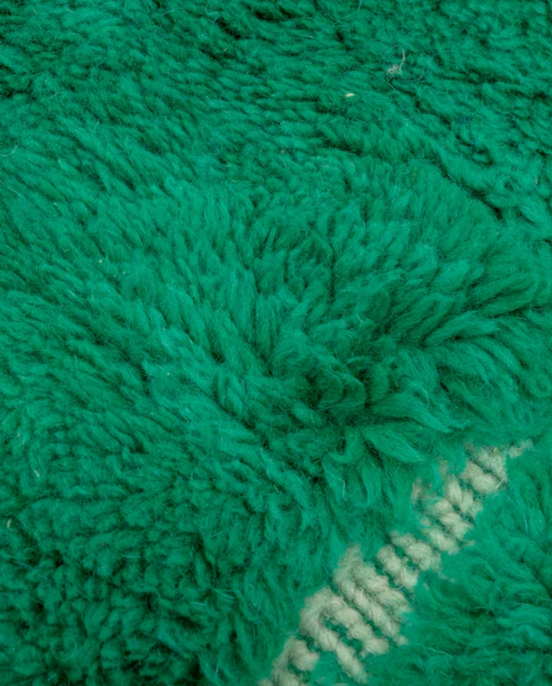 MAYSAA Beni Ourain emerald irregular grid Moroccan rug close-up showing hand-knotted wool texture and pile detail, by NURA