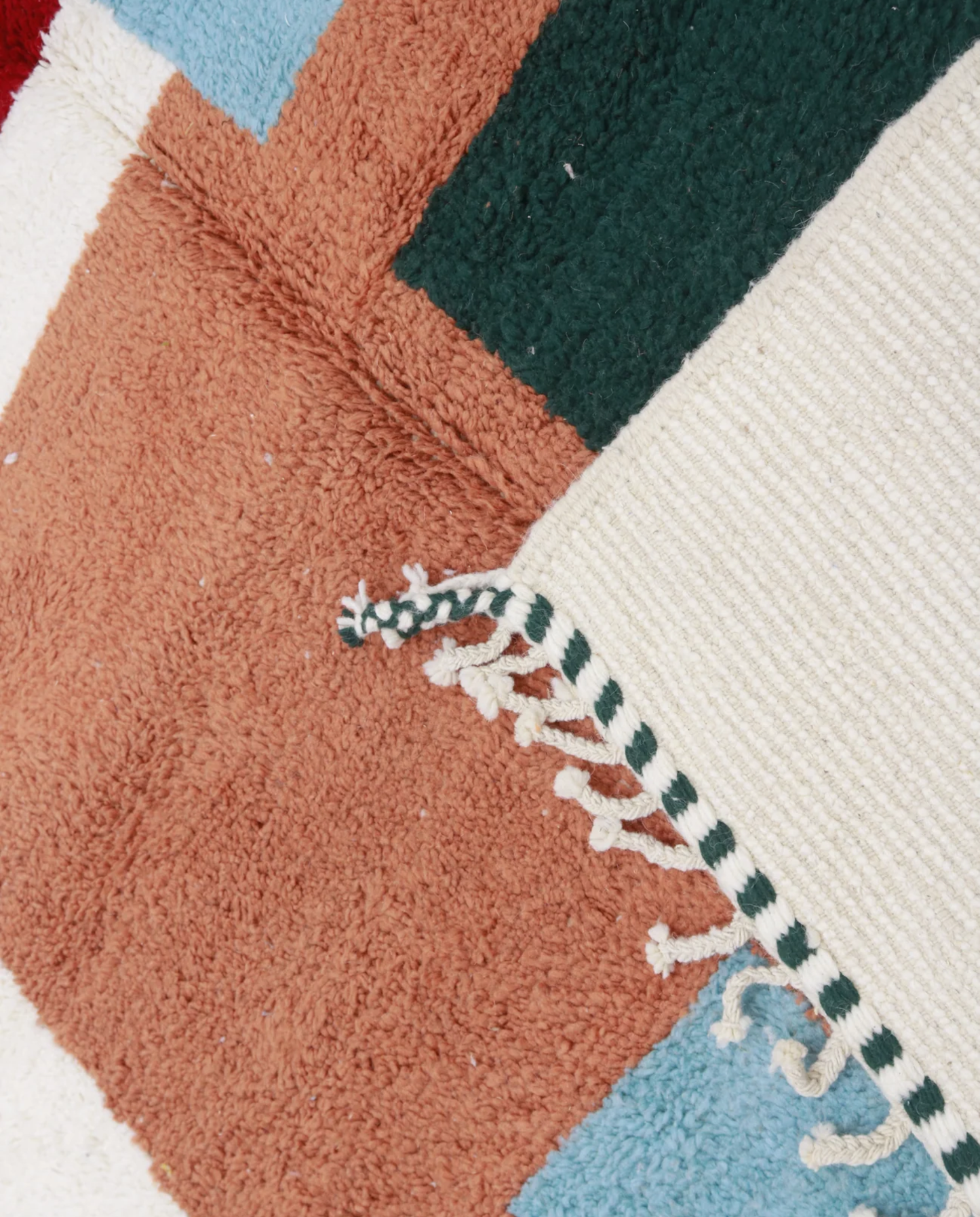 MELULA Azilal cream color block Moroccan rug close-up of hand-tied fringe and kilim band detail, by NURA