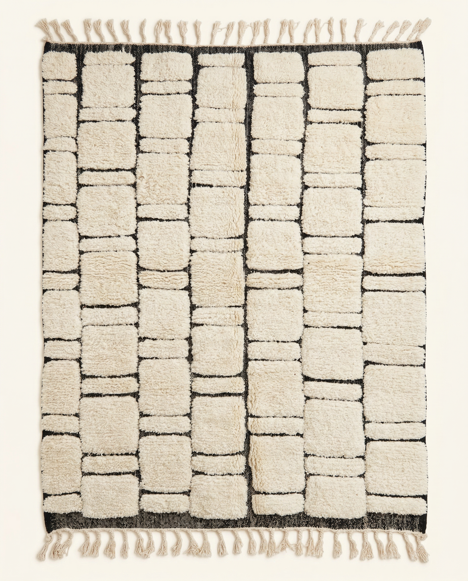 Plush ivory Beni Ourain Moroccan rug with a bold black abstract block grid and high-low texture, by NURA.