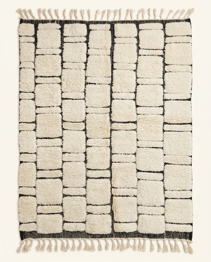 Plush ivory Beni Ourain Moroccan rug with a bold black abstract block grid and high-low texture, by NURA.