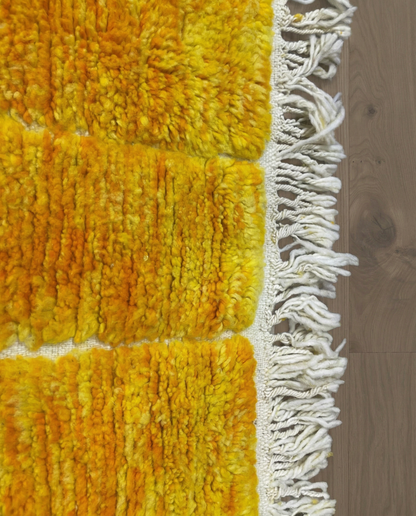 MIRA Beni Ourain saffron raised block grid Moroccan rug close-up of hand-tied fringe and kilim band detail, by NURA
