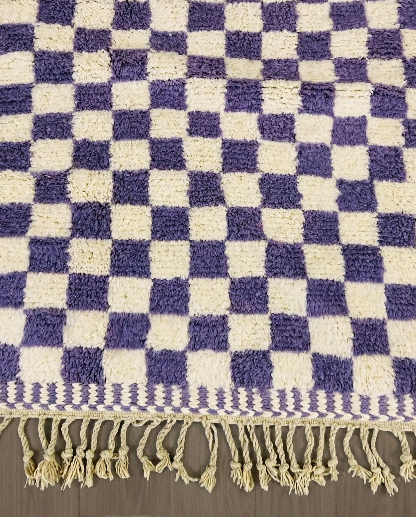 MOUNA Beni Ourain violet checker grid Moroccan rug close-up of hand-tied fringe and kilim band detail, by NURA